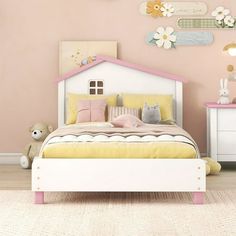 a child's bedroom with pink walls and white furniture