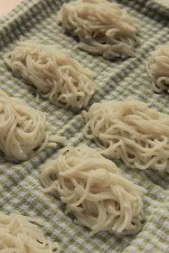 some noodles are sitting on a green and white towel