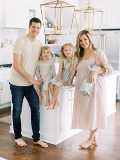 a family posing for a photo in the kitchen