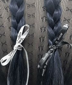 two braids with ribbons tied to them