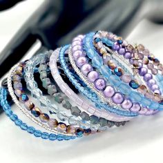 This Lavender Bracelet Is Made On Memory Wire And Will Wrap Around Your Wrist 11 Times. It Is Made With An Assortment Of Glass Beads, Czech Star Beads, Glass Drizzle Beads, And Czech Faceted Glass Crystals, Clear And Matte, All In Shades Of Pretty Purples And Blues, And Topped Off With 2 Crystal Drops On One End. Memory Wire Wrap Bracelets, Crystal Beads Bracelet, Memory Wire, Crystal Drop, Faceted Glass, Blue Crystals, Womens Jewelry Bracelets, Cuff Bracelet, Wrap Bracelet