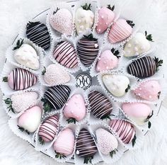 a white plate filled with chocolate covered strawberries on top of a furnishing