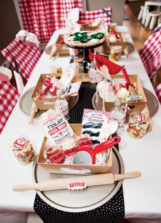 the table is set up with red and white checkered napkins, plates, and utensils