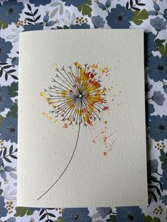 a dandelion painted with watercolors on white paper