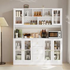 a white cabinet with many items on it and a lamp in the corner next to it