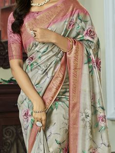 Elevate your ethnic look with our glamorous grey floral printed silk function wear saree with blouse. Made from high-quality silk material, this saree features intricate floral print work and zari weaving work that adds a touch of traditional elegance.
The grey color of the saree is beautifully complemented by the pink color silk material blouse, which also showcases zari weaving work and floral print.
The silk fabric of the saree drapes beautifully and offers a comfortable wear, making it perfe Diwali Gray Saree With Pallu, Eid Floral Print Art Silk Saree, Gray Saree With Pallu, Gray Saree For Diwali, Saree Drapes, Ethnic Looks, Dusty Purple, Wear Saree, Silk Material