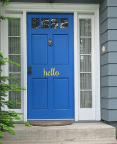 a blue front door on a gray house