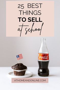 a cupcake with an american flag on it next to a bottle of coca cola