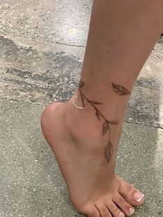 a woman's foot with leaves on it