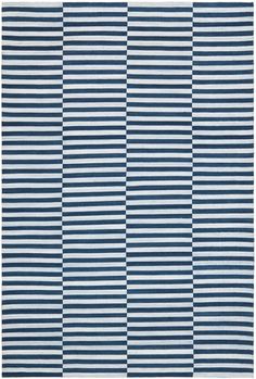 a blue and white rug with vertical stripes