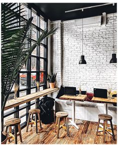 an office with white brick walls and wooden floors