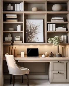 a desk with a laptop and some books on it in front of a book shelf