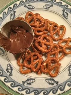 a plate with pretzels and chocolate spread on it