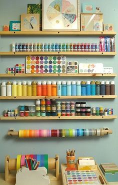 there are many crafting supplies on the shelves in this room, including crayons and markers