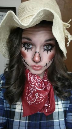 a woman with makeup on her face wearing a cowboy hat