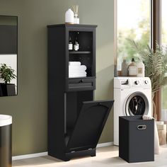 a washer sitting next to a dryer in a room with green walls and white flooring