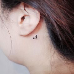 a small music note tattoo on the left ear