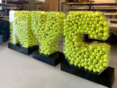 there are many tennis balls on display in the store