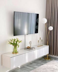 a living room with a large flat screen tv mounted to the side of a wall