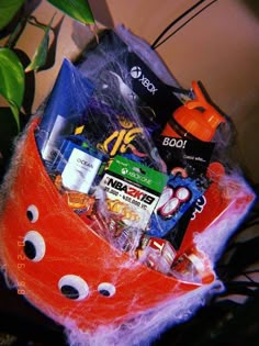 a basket filled with various items sitting on top of a table next to a potted plant