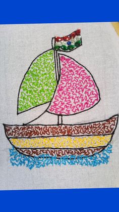 an embroidered sailboat on a white shirt with multicolored details and a flag