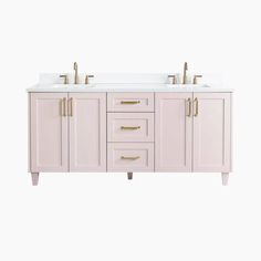 the double sink vanity has two gold faucets on each side and is white