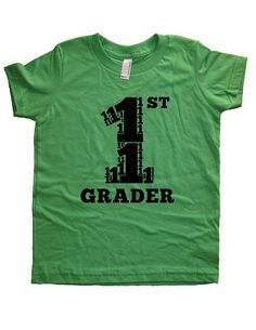 First Grader: Cute School Shirt for Your First GraderThis super soft, pre-shrunk, 100% cotton shirt is designed and printed by us. It is comfortable, durable, and soft. This shirt is gift-friendly, and it arrives wrapped in tissue paper.☆COLORS and SIZES AVAILABLE☆SHIRT COLORS: Purple, Green, Gray, Hot Pink, BlueSIZES: 2T, 4T, 6, 8, 10, 12The INK COLOR is:Black on Green and Gray; Light Blue on Blue; Pink on Hot Pink and PurpleGrades Kindergarten through 5th Grade available: http://www.etsy.com/s Short Sleeve Cotton Shirt With Number Print, Cotton Short Sleeve Shirt With Number Print, Green Letter Print T-shirt For End Of School Year, Green Text Print T-shirt For School, Green Graphic Print School Shirt, Green Graphic Print Shirt For School, Green Letter Print Top For Birthday, Green School Tops With Text Print, Green Tops With Name Print For Birthday