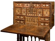 an old wooden desk with many drawers on the top and bottom, sitting in front of a white background