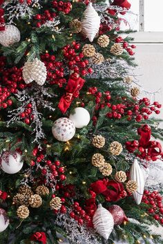 a decorated christmas tree with red and white ornaments