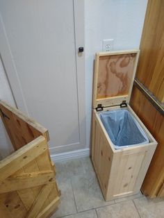 two wooden boxes sitting next to each other on the floor in front of a door