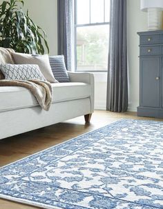 a blue and white rug in a living room