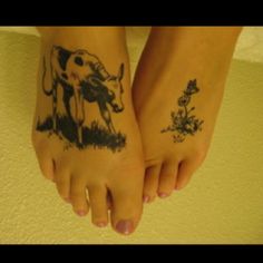 two people with tattoos on their feet are standing next to each other and one has a cow