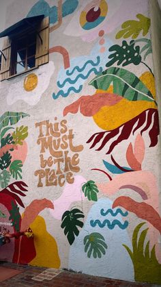 a mural on the side of a building that says, this must be the place