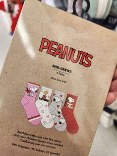 a person holding up a box with some cute socks on it's front cover