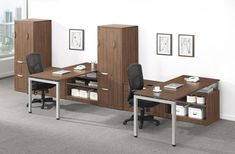 an office cubicle with two desks and chairs