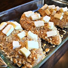 three pieces of bread with cheese on top in a baking pan, ready to be baked