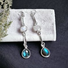 These dazzling long sterling silver earrings with etherial Labradorite and Moonstone semi-precious stones are perfect for a night out or when you want to amp up for outfit for the day! By Elizabeth Burry Design (Trinity, NL) Metal: 0.925 Sterling Silver Measures 2.75"L Elegant Nickel-free Labradorite Earrings, Elegant Labradorite Drop Earrings, Elegant Labradorite Dangle Earrings, Elegant Labradorite Jewelry For Pierced Ears, Labradorite Dangle Jewelry With Matching Earrings, Sterling Silver Drop Earrings With Gemstone Accents, Moonstone Dangle Earrings With Gemstone Accents, Moonstone Drop Earrings With Gemstone Accents, Dangle Moonstone Jewelry With Gemstone Accents