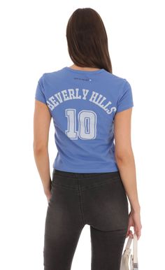 Heart Beverly Hills T-Shirt in Blue | LUCY IN THE SKY Blue Cotton Tops With Letter Print, Light Blue Pre-shrunk Cotton T-shirt, Blue Cotton Tops With Text Print, Washed Blue Cotton Crew Neck T-shirt, Washed Blue Cotton Tops, Washed Blue Cotton Crew Neck Top, Washed Blue Cotton Top With Letter Print, Blue Cotton Soft-washed Top, Soft-washed Blue Cotton Top