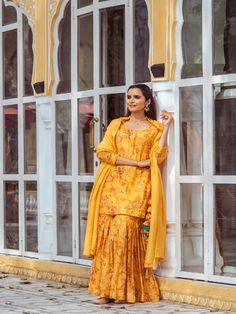 Yellow Floral Printed Cotton Silk Gharara Set now available at Trendroots Yellow Chanderi Sharara With Printed Motifs, Yellow Palazzo Set With Printed Motifs In Traditional Drape, Anarkali Sets With Printed Motifs In Yellow, Yellow Palazzo Set With Printed Motifs And Traditional Drape, Traditional Yellow Palazzo Set With Printed Motifs, Chanderi Sharara With Printed Motifs For Festivals, Festive Chanderi Sharara With Printed Motifs, Chanderi Sharara With Printed Motifs For Eid, Chanderi Sharara With Printed Motifs