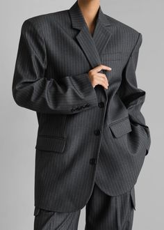 Color: Grey/White Pinstripe Midweight traditional suiting fabric Oversized fit Notch lapels Padded shoulders Button cuffs Single welt breast pocket Front illusion flap pockets Front button closure Lined 75% Polyester 25% Rayon Dry Clean By The Frankie Shop. Imported Pinstripe Business Outerwear With Pockets, Pinstripe Business Blazer With Pockets, Business Pinstripe Outerwear With Pockets, Pinstripe Lapel Collar Outerwear For Work, Pinstripe Outerwear With Lapel Collar For Work, Tailored Pinstripe Blazer With Pockets, Pinstripe Blazer With Notch Lapel And Pockets, Tailored Striped Suits With Pockets, Classic Striped Suits With Pockets