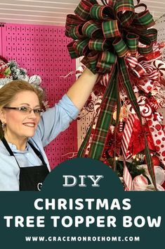 a woman holding up a christmas tree topper bow