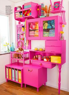 a pink desk with lots of drawers and shelves