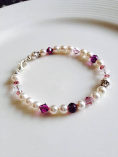 This gorgeous bracelet is made of white Swarovski crystal pearls and is complementing by various shades of purples and white Swarovski bicone crystals and purple jade beads.  Absolutely stunning! To see my other pearl jewelry: https://www.etsy.com/ca/shop/SimpleEleganceByJ?search_query=pearl To see my other beaded bracelets: https://www.etsy.com/ca/shop/SimpleEleganceByJ?section_id=20126609 To check out the rest of my shop: https://www.etsy.com/ca/shop/SimpleEleganceByJ Thanks for stopping by! Candy Bracelet, Beaded Jewelry Bracelets, Embroidery Bracelets, Beaded Bracelets Tutorial, Bridal Bracelet, Amethyst Beads, Design Jewelry, Gorgeous Bracelet, Bracelet Tutorial