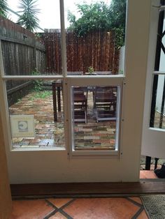 an open door leading to a back yard