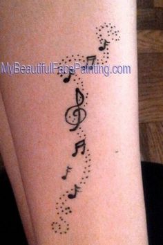 a tattoo with musical notes on it