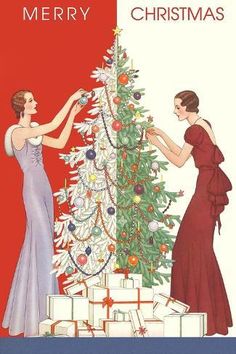 two women decorating a christmas tree with red and white greetings on the front