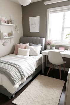 a bedroom with a bed, desk and chair next to a window in the corner