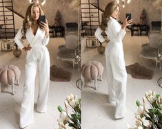 a woman in white is taking a selfie with her cell phone while standing in front of a mirror