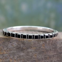 This bold and eye-catching bangle bracelet is the creation of Bhavesh in India. A sleek sterling silver circlet is studded with square-cut black onyx that totals 26 carats. The polished settings of the gems contrast beautifully with a darkly oxidized patina for a look that is all about contemporary chic.