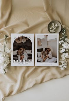 two polaroid photos sitting on top of a bed next to flowers